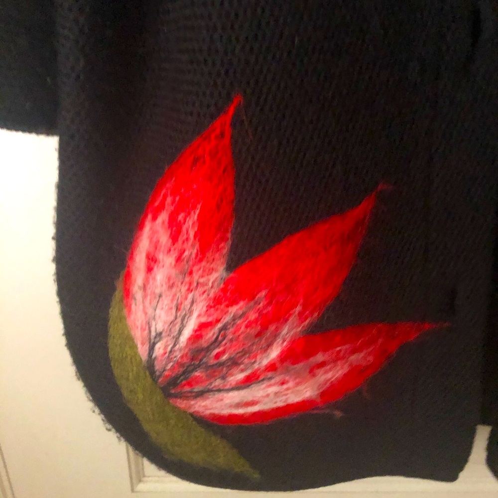 Oversized black sweater with red flower detail